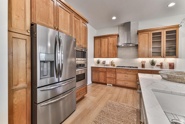 38 S 1840 W, St George, UT 84770 - kitchen with light stone counters, stainless steel appliances, wall chimney range hood, decorative backsplash, and glass insert cabinets
