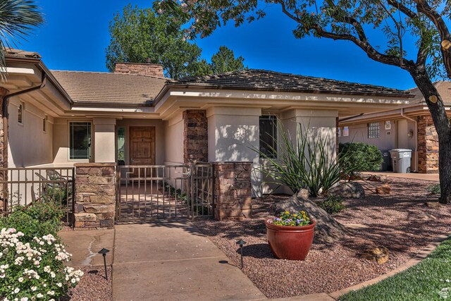 38 S 1840 W, St George, UT 84770 - ranch-style house with a chimney, stucco siding, a gate, fence, and stone siding