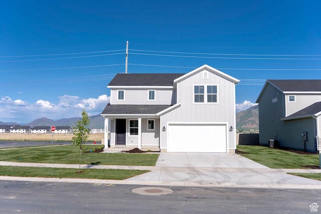 1686 N 800 W, Salem, UT 84653 - view of front of house featuring driveway, a front lawn, an attached garage, roof with shingles, and a mountain view