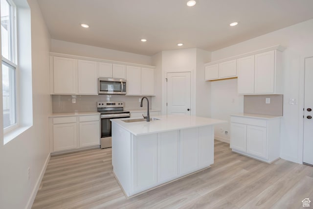 1686 N 800 W, Salem, UT 84653 - kitchen featuring stainless steel appliances, a sink, light wood-style floors, white cabinets, and recessed lighting