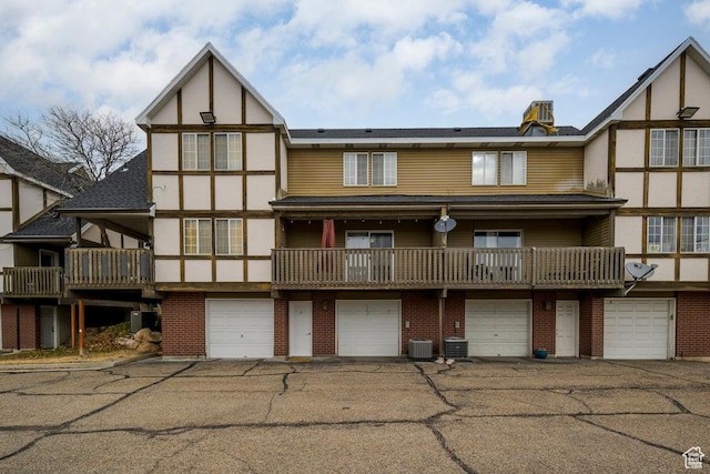 488 E 200 S Unit A3, Clearfield, UT 84015 - back of house featuring cooling unit, brick siding, and an attached garage