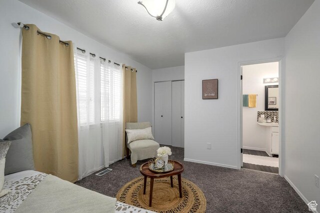 488 E 200 S Unit A3, Clearfield, UT 84015 - bedroom featuring ensuite bathroom, dark carpet, visible vents, and baseboards