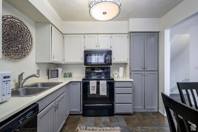 488 E 200 S Unit A3, Clearfield, UT 84015 - kitchen with gray cabinets, light countertops, stone finish floor, a sink, and black appliances