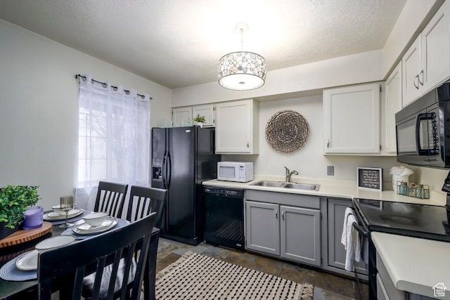 488 E 200 S Unit A3, Clearfield, UT 84015 - kitchen with light countertops, gray cabinetry, stone finish flooring, a sink, and black appliances