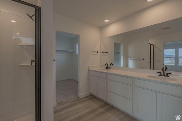 1656 N 800 W, Salem, UT 84653 - full bath with a stall shower, wood finished floors, a walk in closet, double vanity, and baseboards