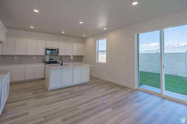 1656 N 800 W, Salem, UT 84653 - kitchen with stainless steel appliances, light countertops, light wood finished floors, white cabinetry, and recessed lighting