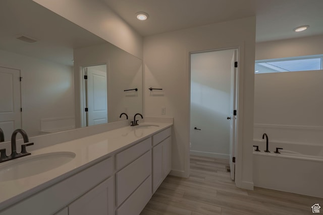 1656 N 800 W, Salem, UT 84653 - full bathroom featuring double vanity, a garden tub, wood finished floors, recessed lighting, and baseboards