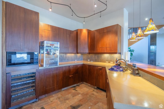 1558 N Harvard Ave, Washington, UT 84780 - kitchen featuring modern cabinets, decorative light fixtures, a sink, black microwave, and backsplash