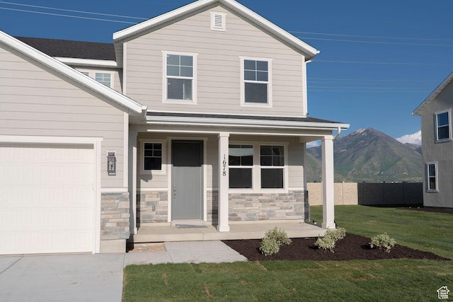 1678 N 800 W, Salem, UT 84653 - view of front of property featuring covered porch, a mountain view, an attached garage, stone siding, and concrete driveway