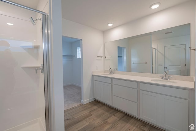 1678 N 800 W, Salem, UT 84653 - bathroom with a stall shower, wood finished floors, double vanity, a spacious closet, and baseboards
