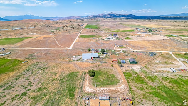 birds eye view of property with a mountain view and a rural view