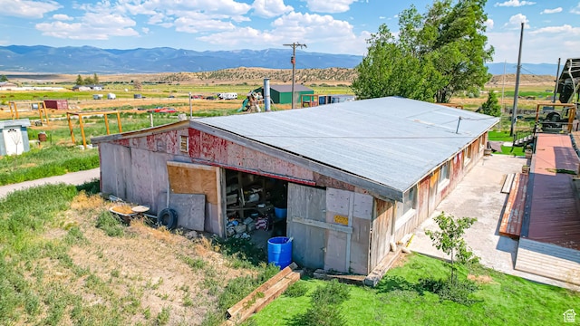 exterior space featuring an outbuilding, a pole building, metal roof, and a mountain view