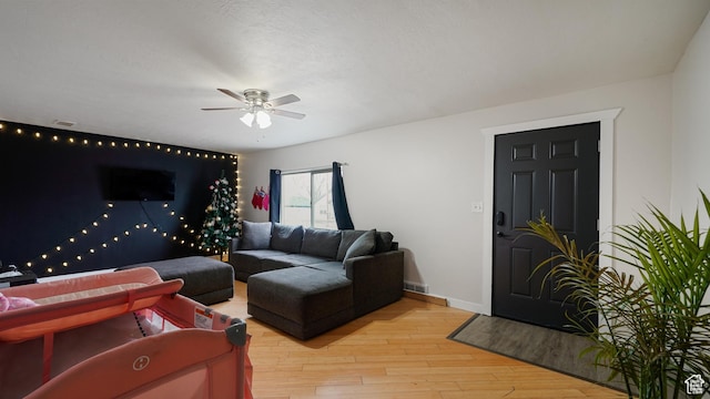 2812 S 9150 W, Magna, UT 84044 - living area featuring ceiling fan, wood finished floors, visible vents, and baseboards