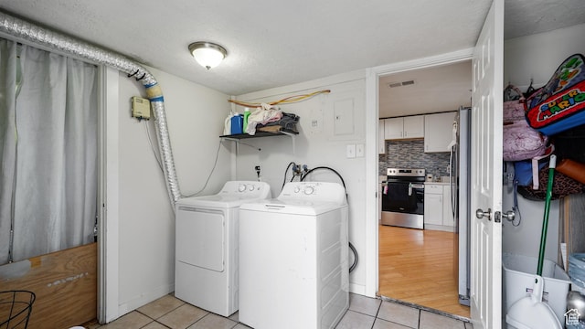 2812 S 9150 W, Magna, UT 84044 - laundry room featuring light tile patterned floors, a textured ceiling, laundry area, visible vents, and washer and dryer