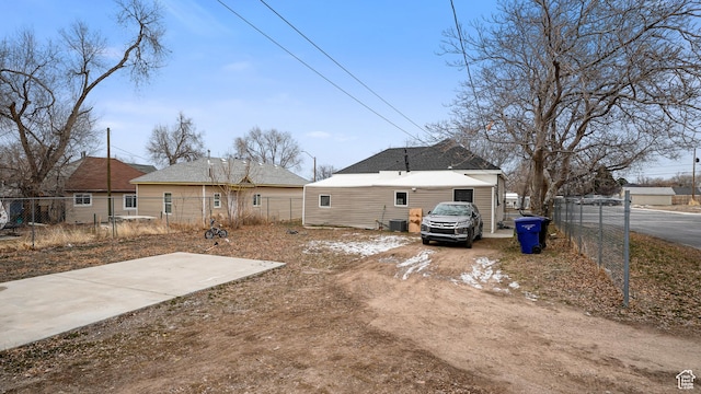 2812 S 9150 W, Magna, UT 84044 - rear view of house with fence, dirt driveway, and central air condition unit