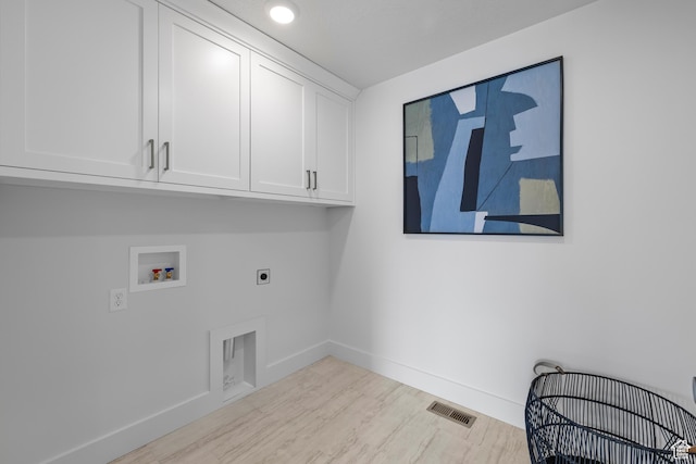 2452 W 2950 N Unit 112, Farr West, UT 84404 - laundry room featuring washer hookup, light wood finished floors, cabinet space, visible vents, and hookup for an electric dryer