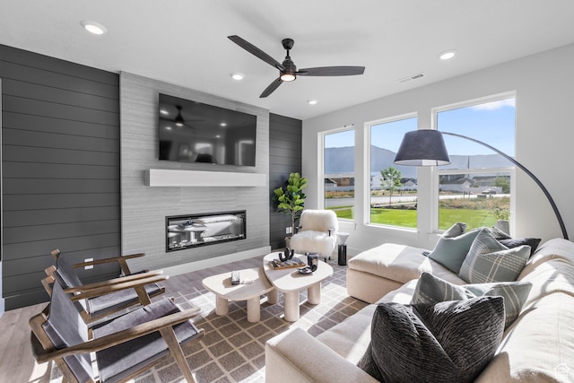 2452 W 2950 N Unit 112, Farr West, UT 84404 - living area with a wealth of natural light, visible vents, a fireplace, and wood finished floors