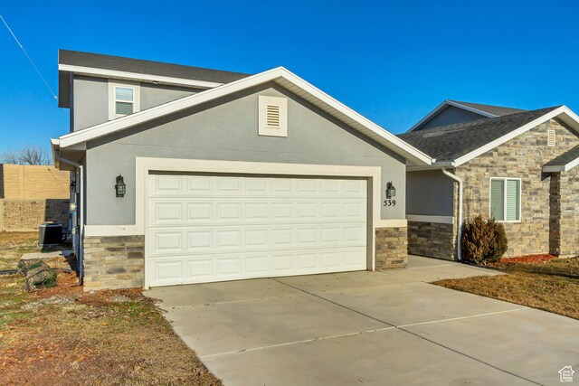 539 N Douglass Dr W, Payson, UT 84651 - view of front facade with a garage, concrete driveway, stone siding, and stucco siding