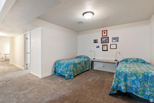 carpeted bedroom with baseboards, visible vents, and a textured ceiling