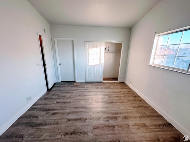 1866 W Homestead Farms Ln S Unit 1, Salt Lake City, UT 84119 - unfurnished bedroom featuring light wood-style floors, multiple windows, and baseboards