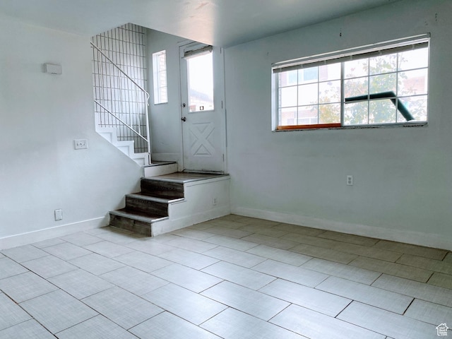 1866 W Homestead Farms Ln S Unit 1, Salt Lake City, UT 84119 - entryway featuring stairs, light tile patterned floors, and baseboards