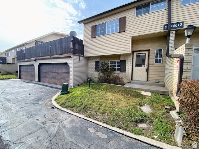 1866 W Homestead Farms Ln S Unit 1, Salt Lake City, UT 84119 - townhome / multi-family property with a garage, driveway, and brick siding