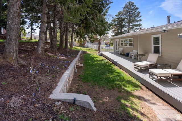 view of yard with a deck and fence
