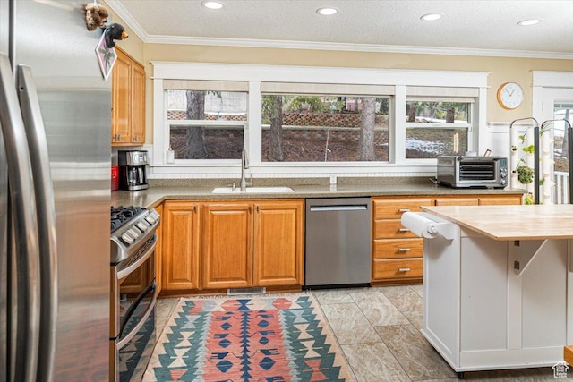 kitchen featuring recessed lighting, a sink, stainless steel appliances, wood counters, and a toaster