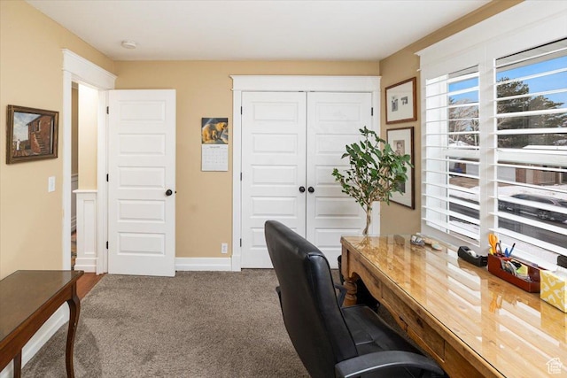 carpeted office space with baseboards