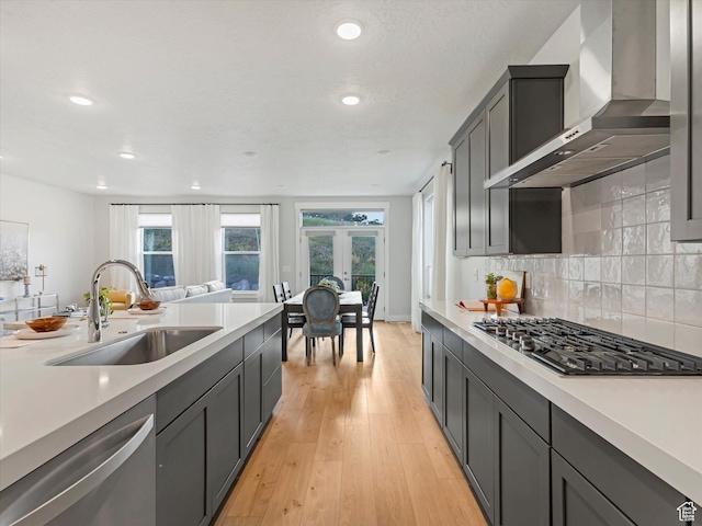 14678 S Silver Blossom Way E, Draper, UT 84020 - kitchen featuring wall chimney range hood, stainless steel appliances, french doors, light countertops, and recessed lighting
