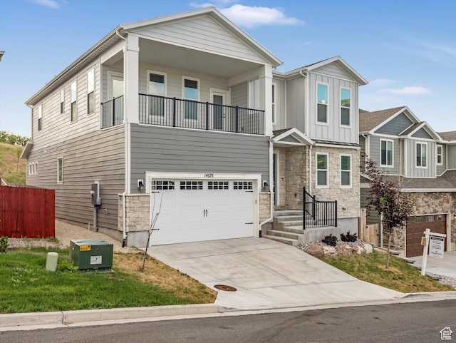 14678 S Silver Blossom Way E, Draper, UT 84020 - view of front of property with a balcony, a garage, concrete driveway, stone siding, and board and batten siding