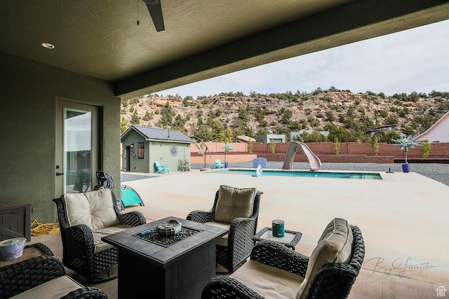 2906 N Purple Sage Rd, Apple Valley, UT 84737 - view of patio featuring a fenced backyard, a fire pit, and a ceiling fan