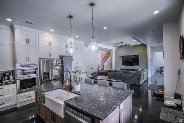 2906 N Purple Sage Rd, Apple Valley, UT 84737 - kitchen featuring a sink, appliances with stainless steel finishes, recessed lighting, white cabinetry, and a kitchen island with sink