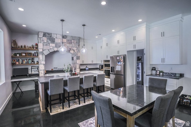 2906 N Purple Sage Rd, Apple Valley, UT 84737 - kitchen featuring appliances with stainless steel finishes, white cabinetry, an island with sink, a breakfast bar area, and recessed lighting