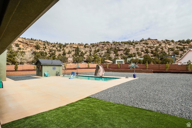 2906 N Purple Sage Rd, Apple Valley, UT 84737 - view of pool with a water slide, a fenced backyard, an outbuilding, and a patio
