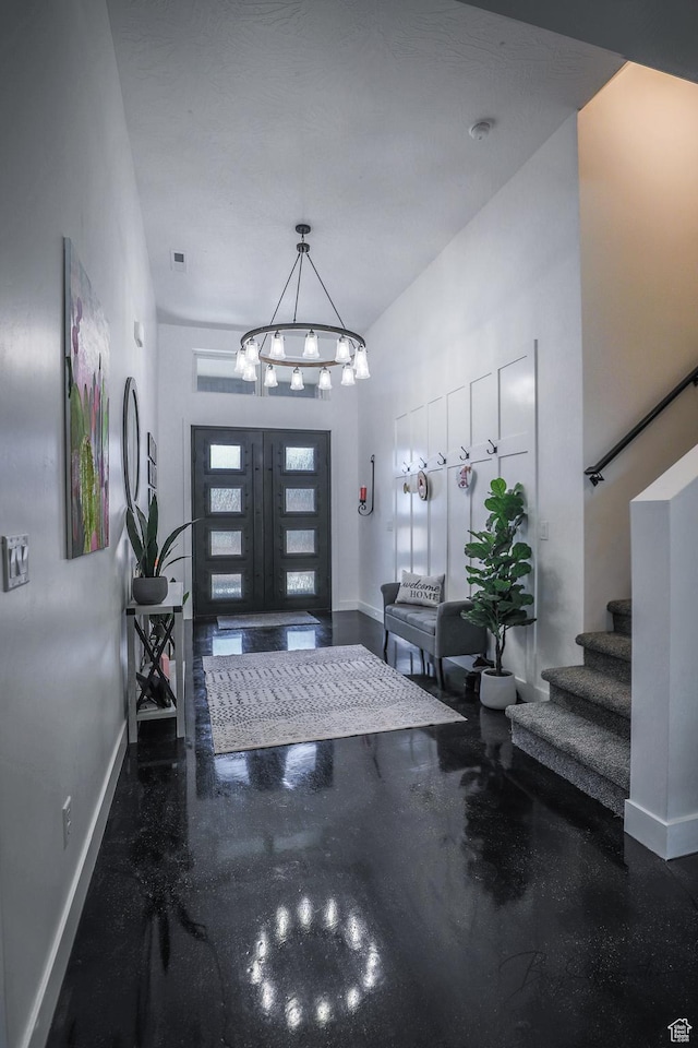 2906 N Purple Sage Rd, Apple Valley, UT 84737 - entrance foyer featuring baseboards, stairs, a chandelier, and concrete flooring