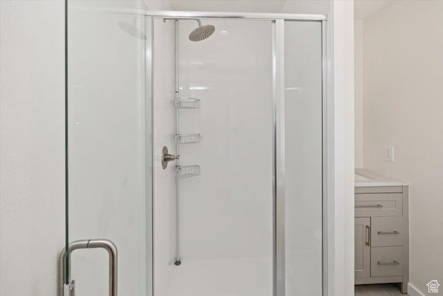 full bathroom featuring vanity and a shower stall