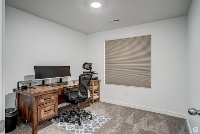 office space featuring visible vents, carpet, and baseboards