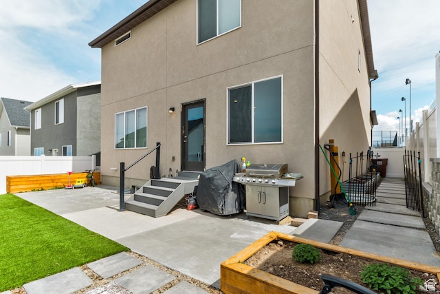 back of property featuring a patio, a fenced backyard, and stucco siding