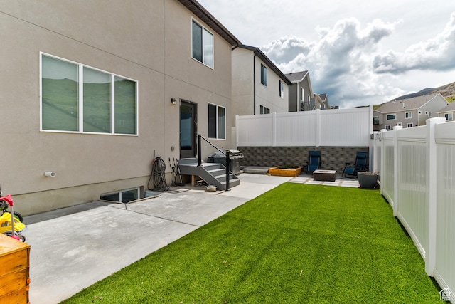 view of yard featuring a fenced backyard, a patio area, and a residential view