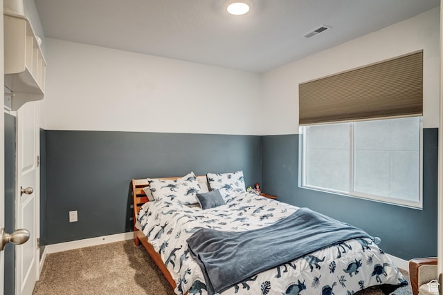 bedroom with carpet floors, baseboards, and visible vents