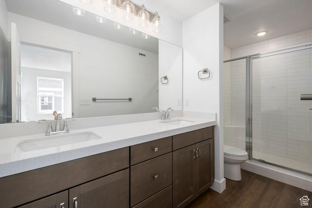 1753 W 160 S Unit 45, Pleasant Grove, UT 84062 - full bathroom featuring toilet, wood finished floors, a stall shower, and a sink