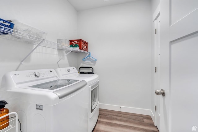 972 W Spider Green Way W Unit E201, Saratoga Springs, UT 84045 - washroom featuring laundry area, independent washer and dryer, baseboards, and wood finished floors
