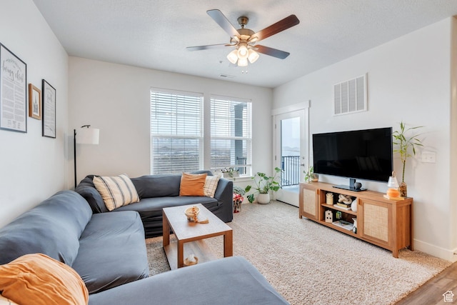 972 W Spider Green Way W Unit E201, Saratoga Springs, UT 84045 - living area featuring a textured ceiling, baseboards, visible vents, and a ceiling fan