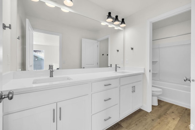 7181 Woods Rose Dr, Park City, UT 84098 - full bath with double vanity, toilet, wood finished floors, and  shower combination