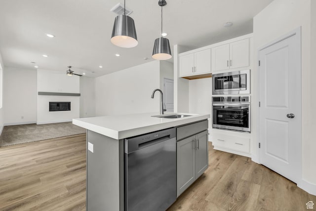 7181 Woods Rose Dr, Park City, UT 84098 - kitchen with appliances with stainless steel finishes, a sink, hanging light fixtures, white cabinets, and light countertops