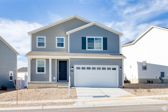 7181 Woods Rose Dr, Park City, UT 84098 - view of front facade with driveway, a garage, covered porch, and cooling unit