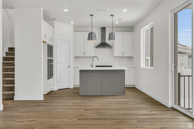 7181 Woods Rose Dr, Park City, UT 84098 - kitchen with wall chimney exhaust hood, plenty of natural light, baseboards, recessed lighting, and white cabinetry