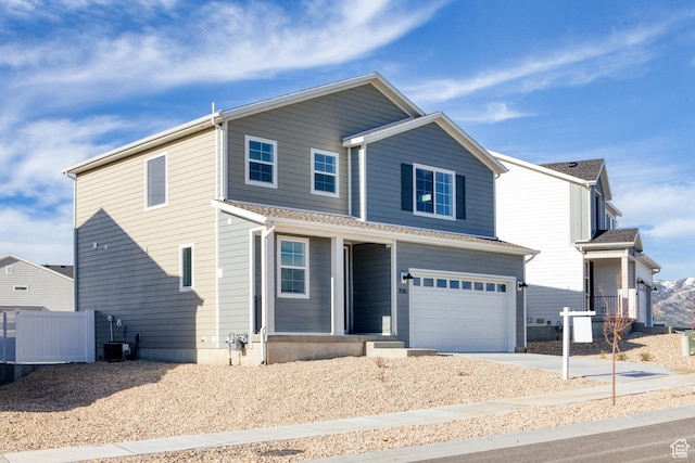 7181 Woods Rose Dr, Park City, UT 84098 - traditional-style house featuring an attached garage, driveway, covered porch, central AC unit, and fence