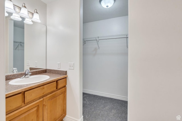 289 S 1000 W Unit 204, Pleasant Grove, UT 84062 - bathroom featuring baseboards, a walk in closet, and vanity